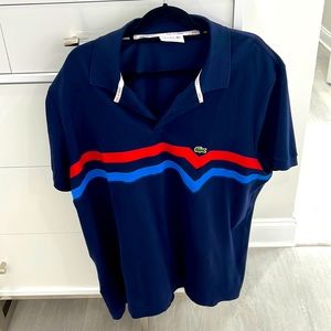 This is a beautiful Lacoste, tennis shirt, red and blue with navy